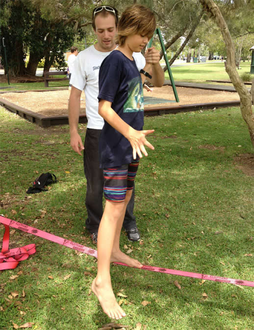 Max gets a hand from Dom as he tries balancing on the slackline for the first time